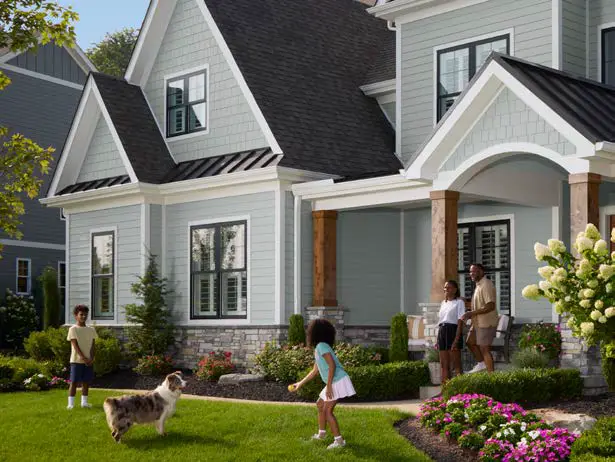 Front view of a home with James Hardie fiber cement siding, showing a family playing in the yard.