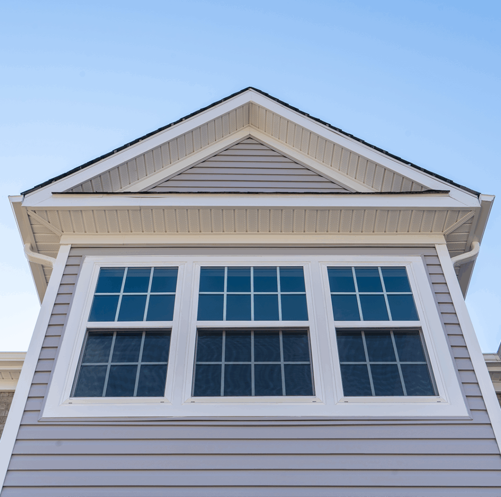 Close-up of new vinyl windows installed on a dormer.