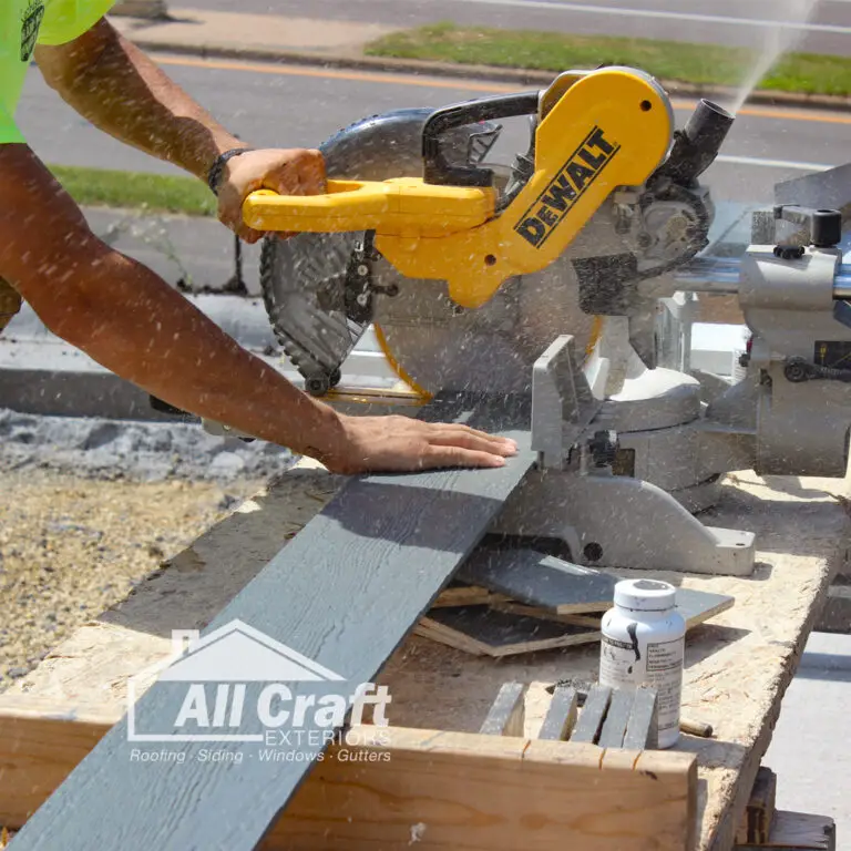 Contractor cutting siding with a chop saw, illustrating local home improvement work and company stability in Minnesota.